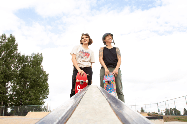 Mentor and mentee skateboarding together